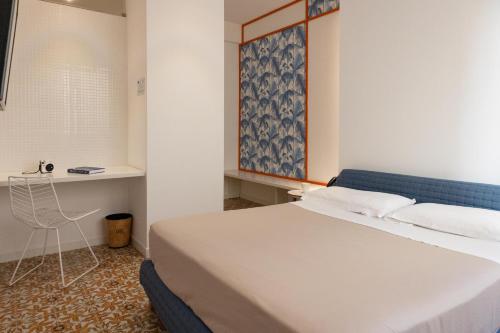 a bedroom with a large bed and a desk at Grand Hotel Riviera - CDSHotels in Santa Maria al Bagno