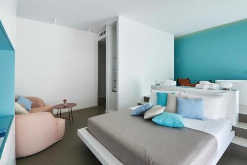a bedroom with a large bed and a chair at Grand Hotel Riviera - CDSHotels in Santa Maria al Bagno