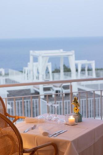 a table with a candle on top of a balcony at Marenea Suite Hotel - CDSHotels in Marittima