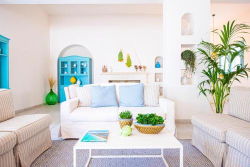 a living room with a white couch and a coffee table at Marenea Suite Hotel - CDSHotels in Marittima