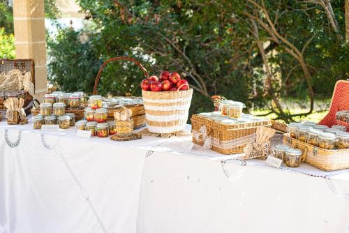 a table with jars and a basket of apples on it at Marenea Suite Hotel - CDSHotels in Marittima