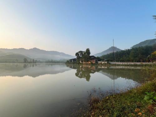 a view of a lake with mountains in the background at Free Yoga Center - Nguyen Shack in Phong Nha