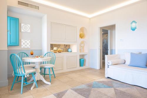 a living room with a table and chairs and a couch at Marenea Suite Hotel - CDSHotels in Marittima