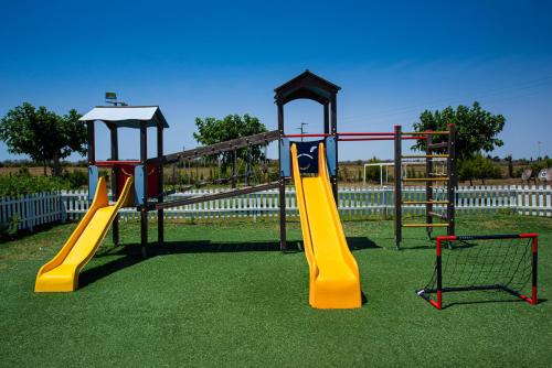 a playground with two slides and a swing at Relais Masseria Le Cesine - CDSHotels in Vernole