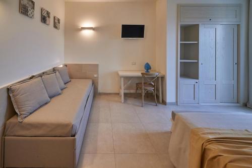 a living room with a couch and a table at Relais Masseria Le Cesine - CDSHotels in Vernole