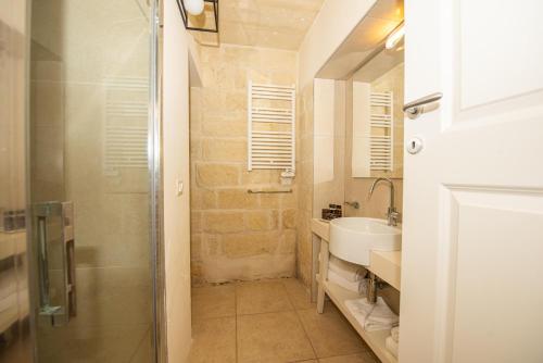 a bathroom with a shower and a sink at Relais Masseria Le Cesine - CDSHotels in Vernole