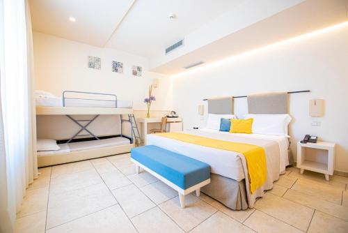 a bedroom with a bed and a bunk bed at Relais Masseria Le Cesine - CDSHotels in Vernole