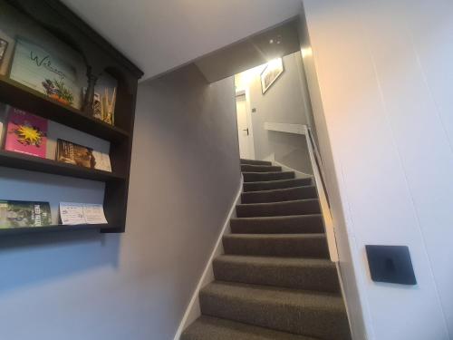 a staircase in a house with a stair case at Peebles High Street Apartment in Peebles