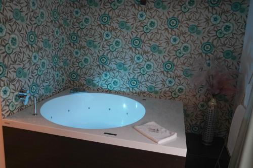 a bathroom with a blue sink on a counter at La Terrazza Antica Dimora in Campobasso