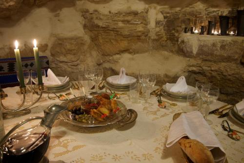 a table with a bowl of food and candles on it at Auberge de Tamezret in Tamezret