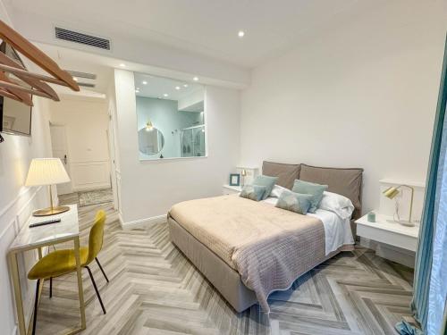 a bedroom with a bed and a table and a chair at La Terrazza Antica Dimora in Campobasso
