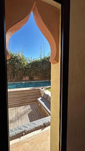 a view from the door of a room with a window at Villa Mattia piscine chauffée sans vis à vis in Marrakech
