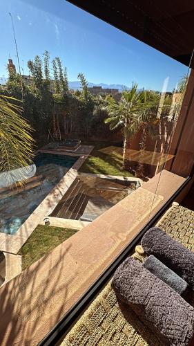 a view of a garden from a window of a house at Villa Mattia piscine chauffée sans vis à vis in Marrakech