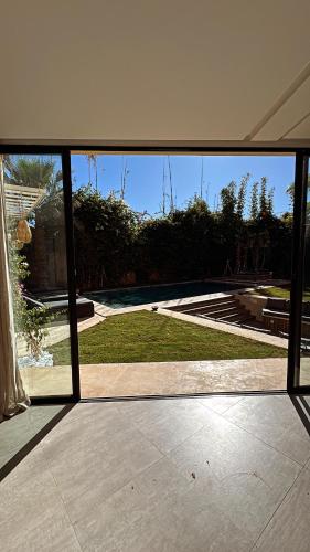 a view from a glass door of a patio at Villa Mattia piscine chauffée sans vis à vis in Marrakech