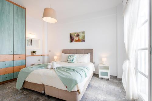 a bedroom with a large bed and a window at Santorini Villatzio Suites in Mesaria