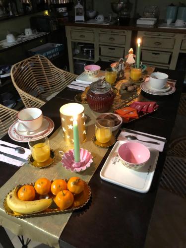 a table with a candle and fruit on it at Hotel Les Embruns in Le Touquet-Paris-Plage