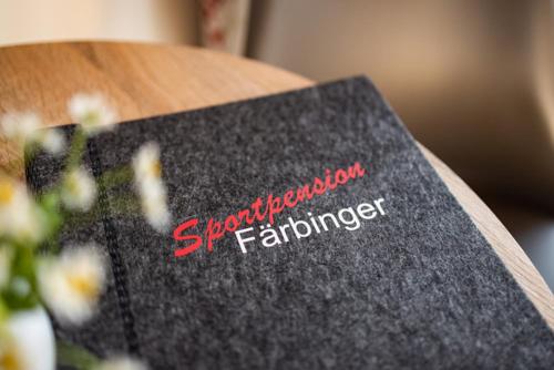 a book sitting on a table with flowers on it at Sportpension Färbinger in Berchtesgaden