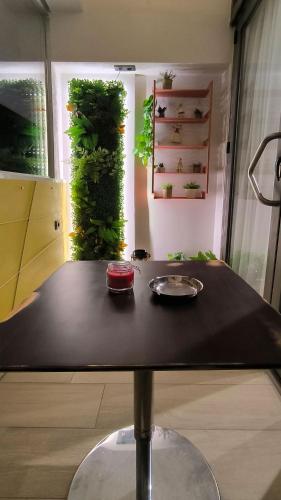 a table in a room with a plant wall at Dk Luxury Studio Xanthi in Xanthi