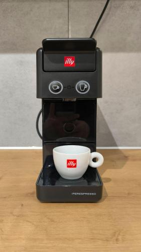 a coffee maker with a cup on a table at Dk Luxury Studio Xanthi in Xanthi
