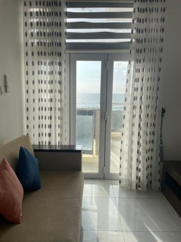 a living room with a couch and a view of the ocean at In the heart of Colombo 2 Bedrooms Apartment in Colombo