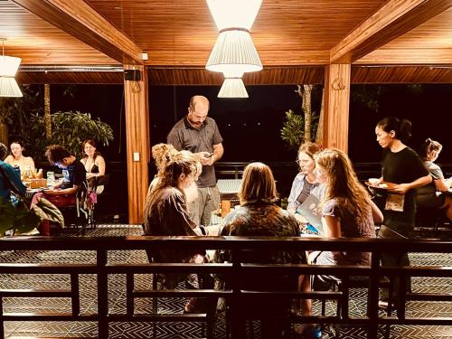 a group of people sitting at a table in a restaurant at Free Yoga Center - Nguyen Shack in Phong Nha