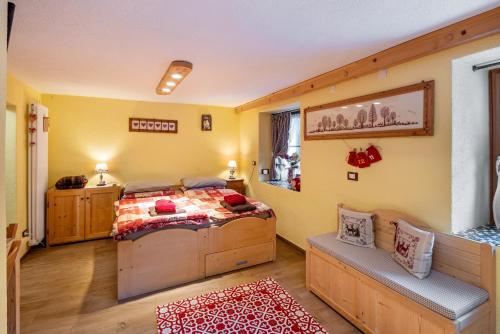 a bedroom with a bed in a room with yellow walls at Ciesa del Selmo Faure in Sottoguda