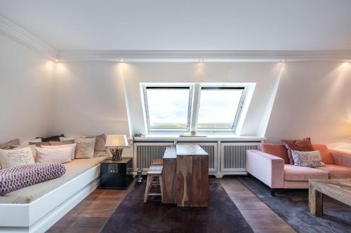 a living room with a couch and a table at Strönhof Kampen in Kampen