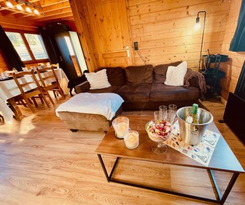 a living room with a couch and a table at Chalet cosy Francorchamps in Stavelot