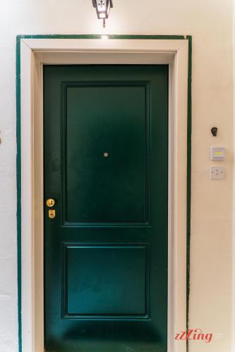 a green door in a building with a light above it at Stunning Holiday Home with Gorgeous Harbour Views in Senglea