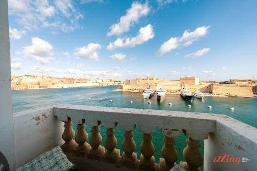 a view from a balcony of boats in the water at Stunning Holiday Home with Gorgeous Harbour Views in Senglea