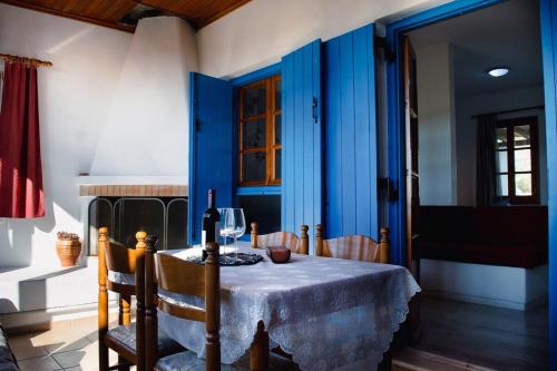 a blue dining room with a table and chairs at Moonlight Kastraki beach house in Kastraki Naxou