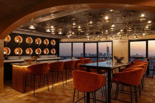 a restaurant with a bar with a view of the city at Dubai Marriott Harbour Hotel And Suites in Dubai
