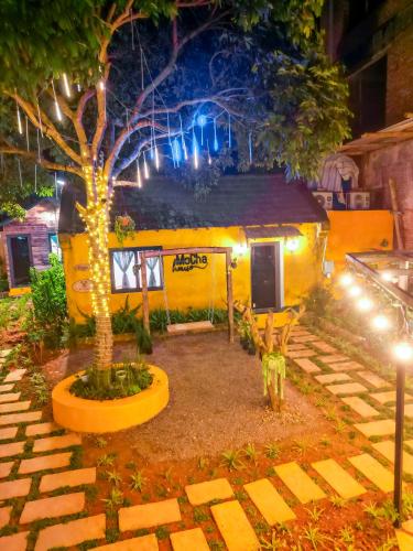 a small yellow caravan with lights on it at night at MoCha House in Làng Môn