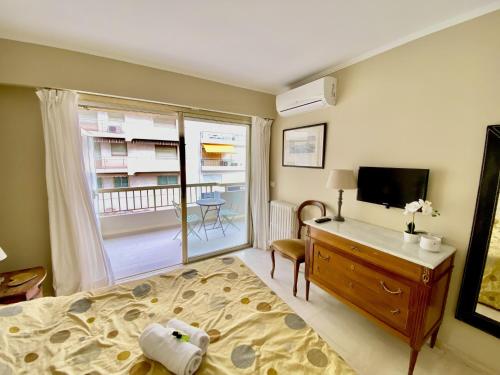 une chambre avec un lit, un bureau et une télévision dans l'établissement Palais Royal Croisette GIA5407, à Cannes
