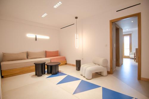 a living room with a couch and a chair at Dionysos Seaside Resort Ios in Mylopotas