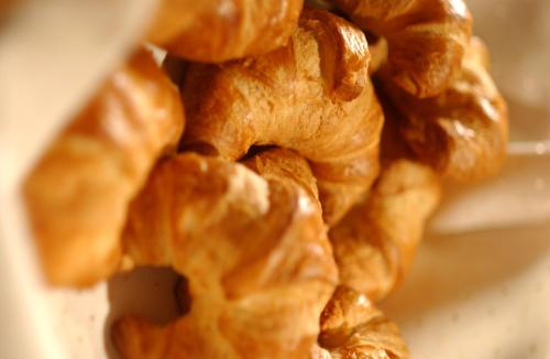 a pile of croissants sitting on a plate at DAS RONACHER Thermal Spa Hotel in Bad Kleinkirchheim