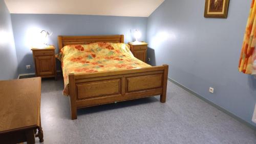 a bed in a room with two nightstands and a bed sidx sidx sidx at La ferme de la fontaine in Douzy