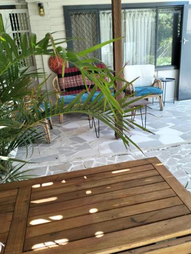 a porch with a bench and plants on a patio at Guest suite-2 beds,private entry, bathroom & laundry in Wollongong