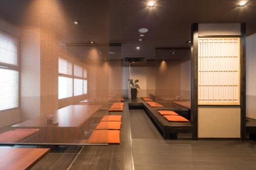 a lobby with a row of sinks and orange pillows at Matsuya Bekkan in Kumamoto