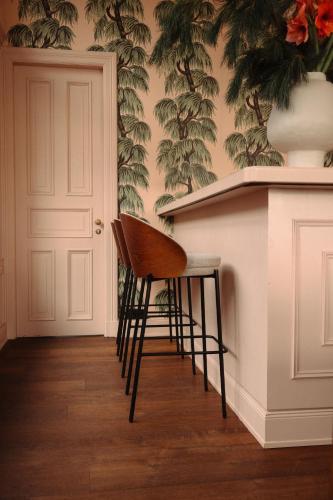 a chair sitting next to a counter in a room at stilwerk Strandhotel Blankenese in Hamburg