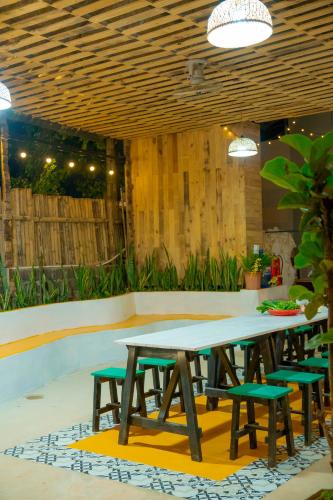 a picnic table and chairs on a patio at MoCha House in Làng Môn