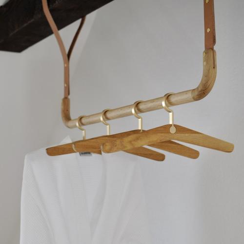 a group of wooden utensils hanging from a rack at Ekenäs Gård på Österlen in Kivik