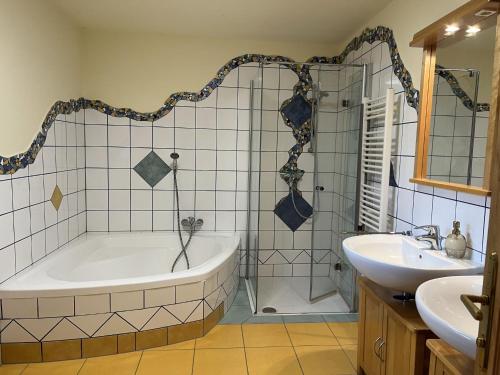 a bathroom with a tub and a sink at Holiday Home Haus Fries by Interhome in Unterbergern