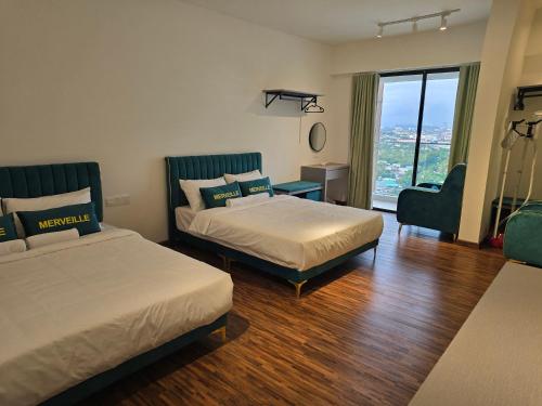 a hotel room with two beds and a window at K Avenue Kota Kinabalu by Merveille - Sabah in Donggongon