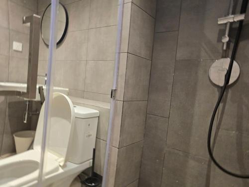 a bathroom with a shower with a toilet and a sink at K Avenue Kota Kinabalu by Merveille - Sabah in Donggongon