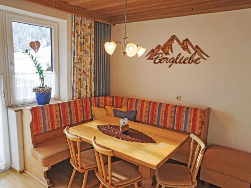 a living room with a table and a couch at Apartment Daheim – Bergliebe by Interhome in Plangeross