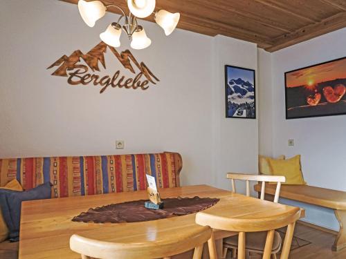 a dining room with a table and a sign on the wall at Apartment Daheim – Bergliebe by Interhome in Plangeross