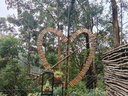 a sculpture of a heart next to a fence at IInfinity Kodaikanal in Kūkkāl