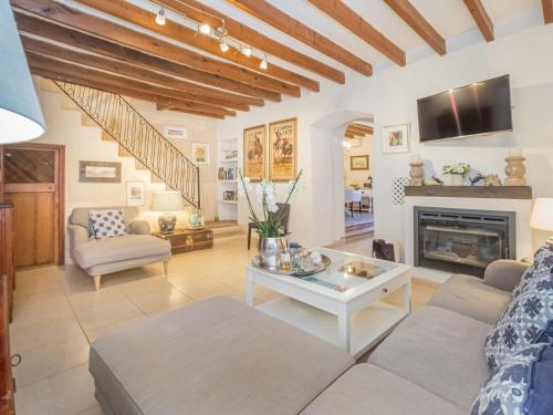 a living room with a couch and a fireplace at Holiday Home Sa Teulera by Interhome in Campanet