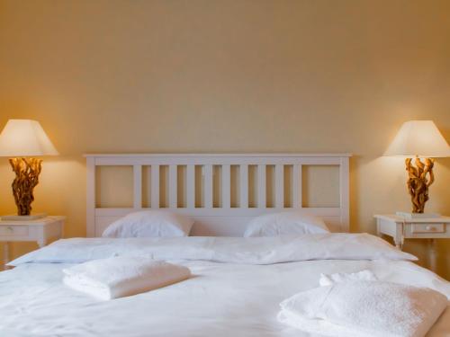 a white bed with two white towels on it at Apartment Cook P1-2 by Interhome in Bouveret